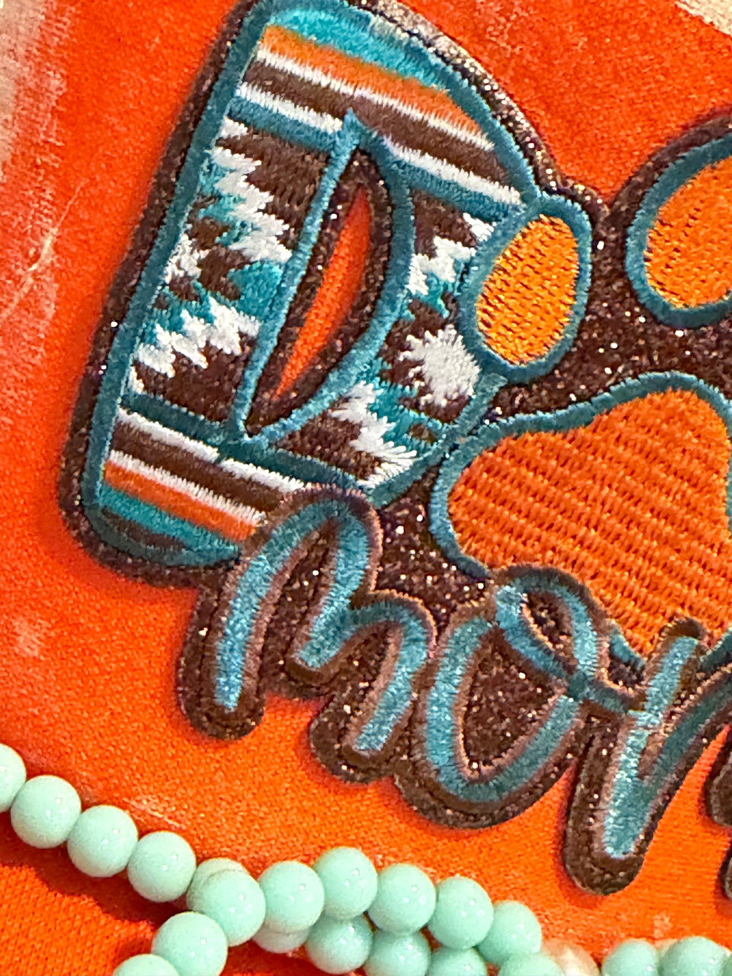 Blu Coconut orange and turquoise dog mom trucker hat