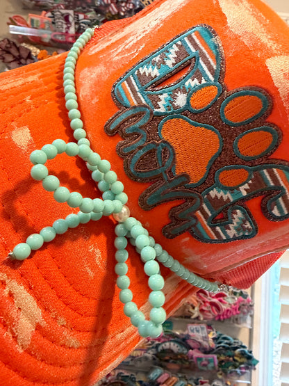 Blu Coconut orange and turquoise dog mom trucker hat