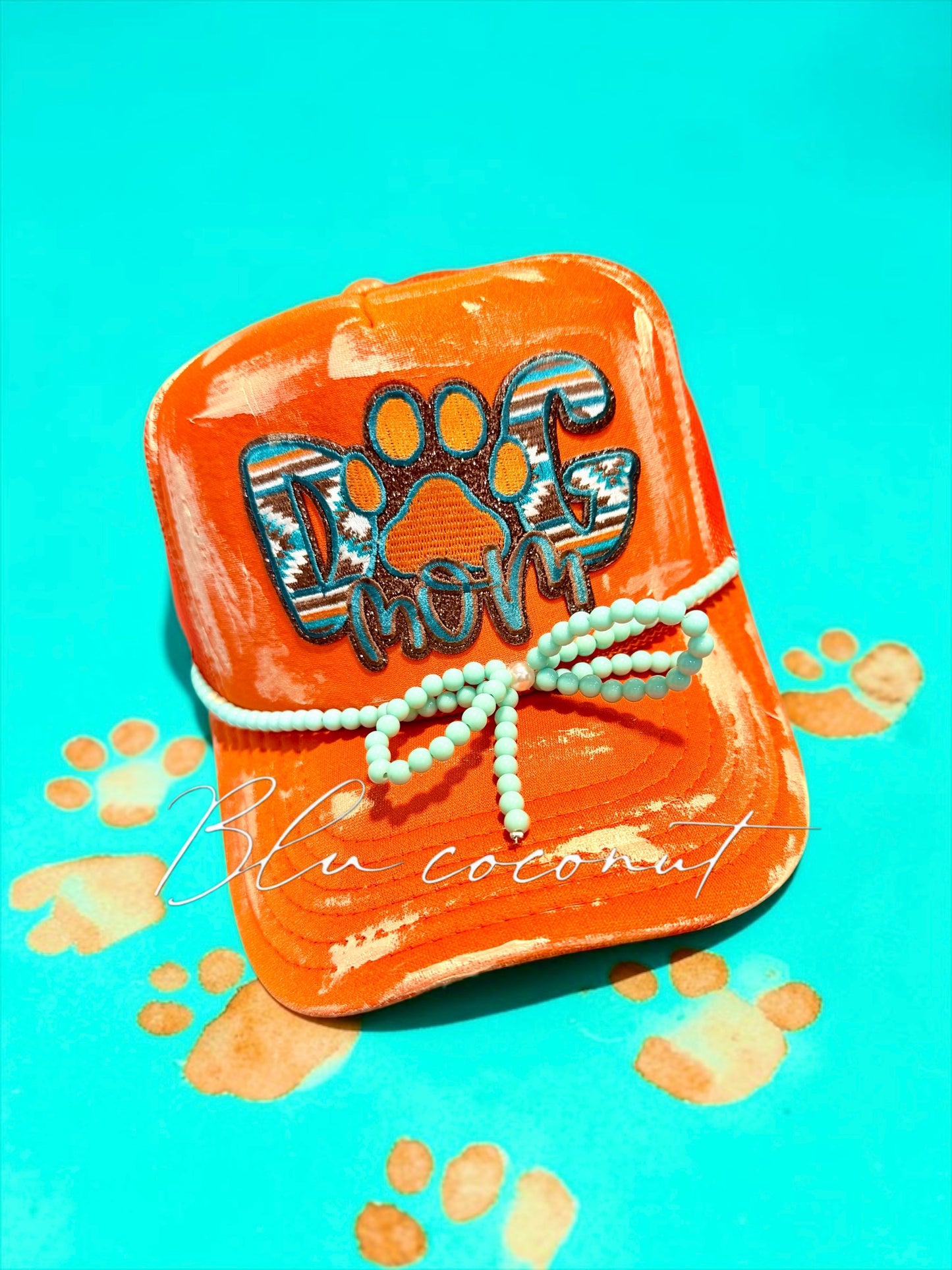 Blu Coconut orange and turquoise dog mom trucker hat