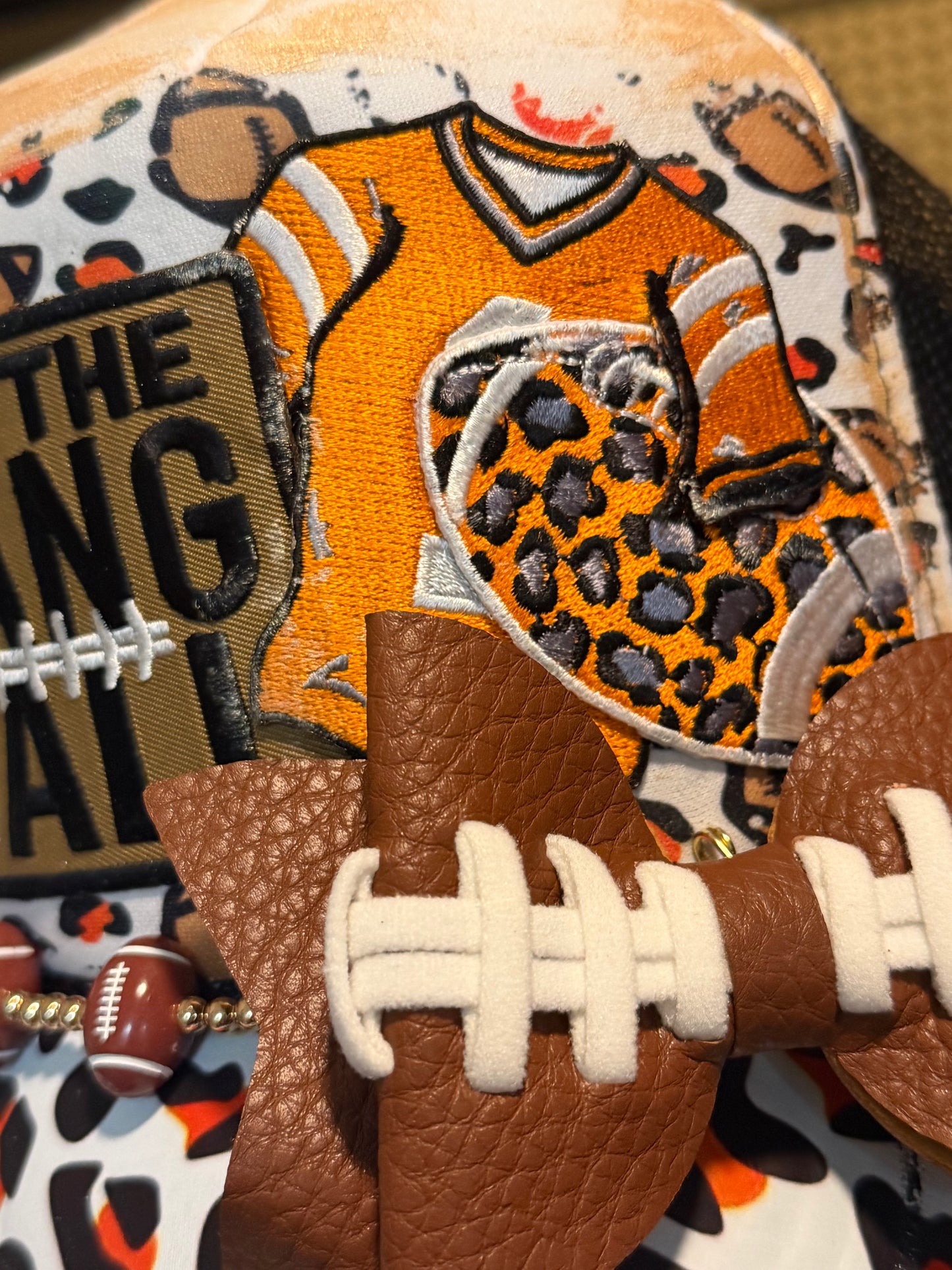 Blue Coconut Black, Orange and White Football Trucker Hat.