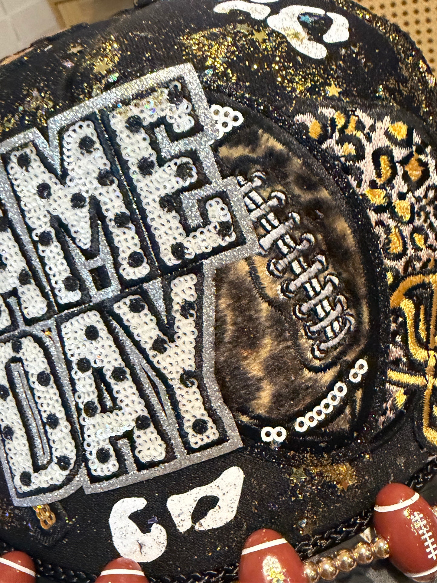 Blu Coconut black, gold and silver Game Day leopard print football trucker hat.