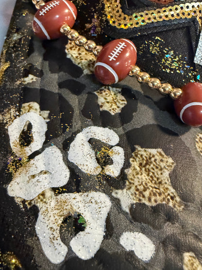 Blu Coconut black, gold and silver Game Day leopard print football trucker hat.