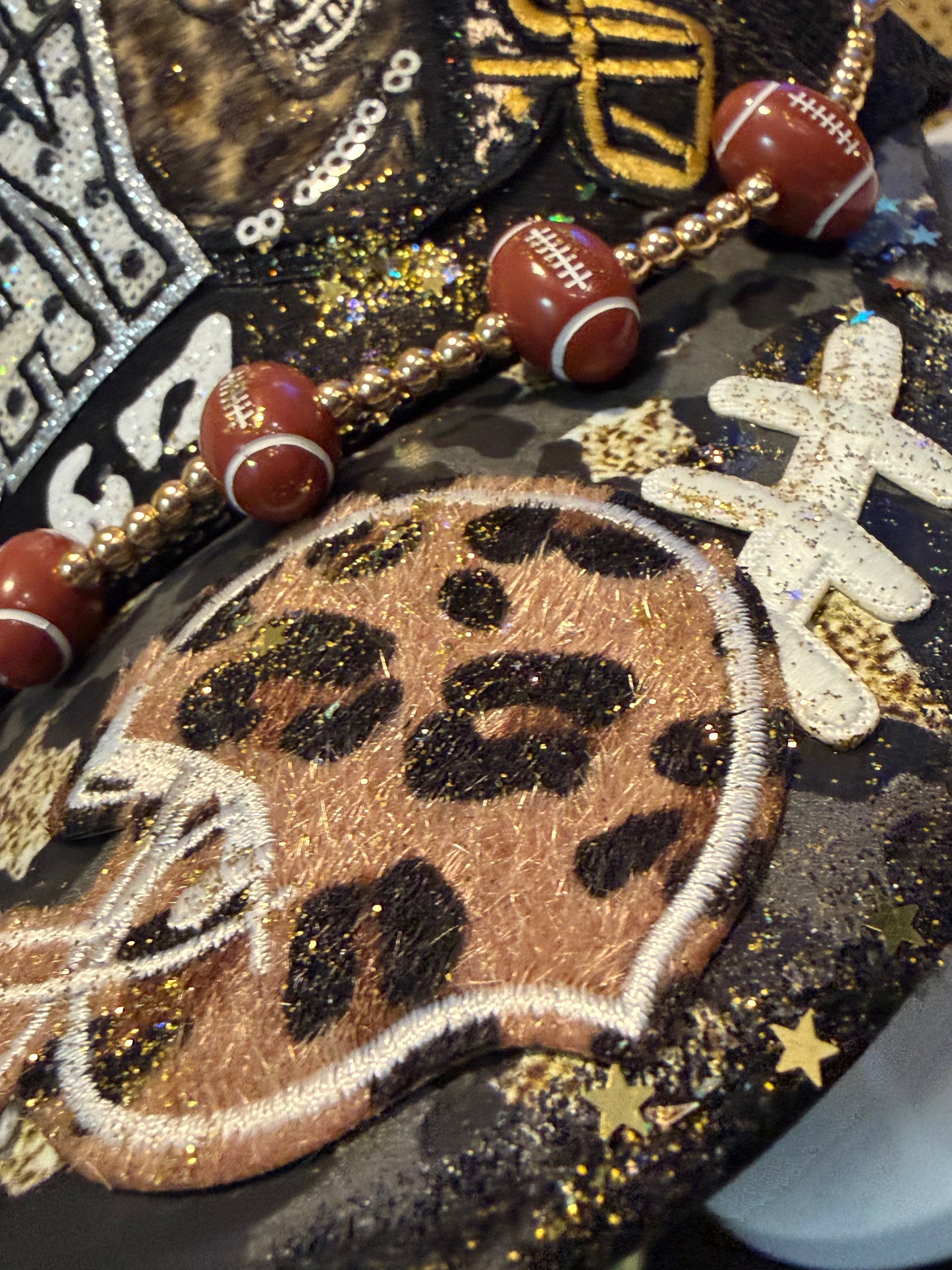 Blu Coconut black, gold and silver Game Day leopard print football trucker hat.