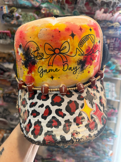 Blu Coconut Black, yellow and red football Trucker Hat