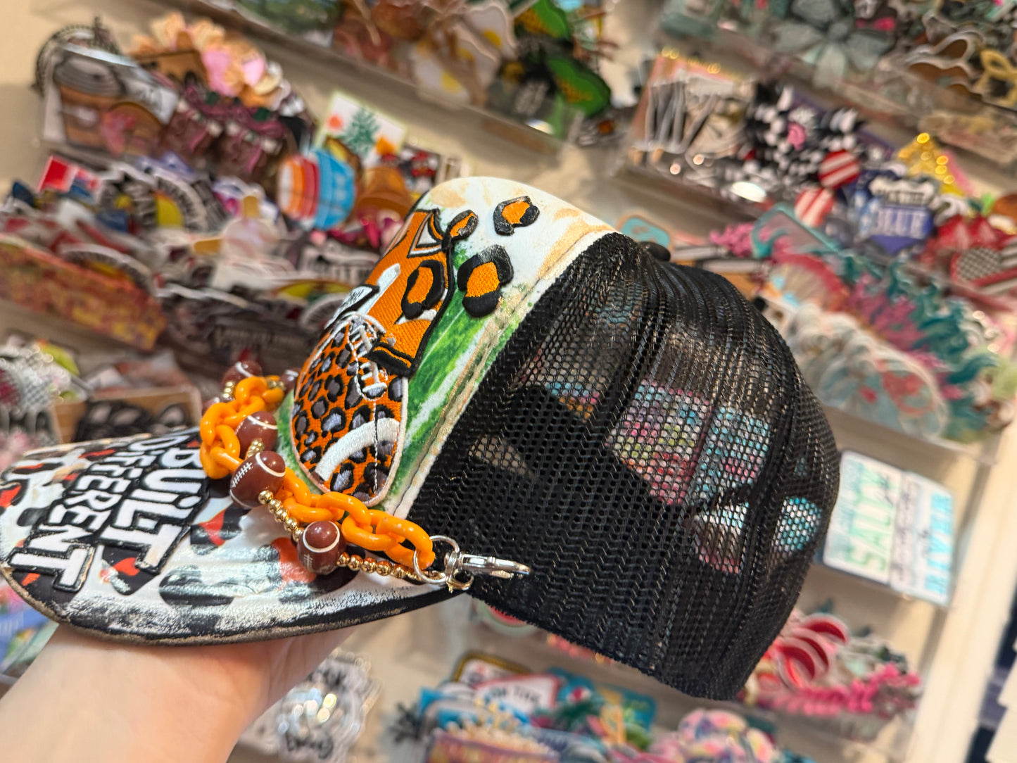 Blu Coconut black white and orange football trucker hat.