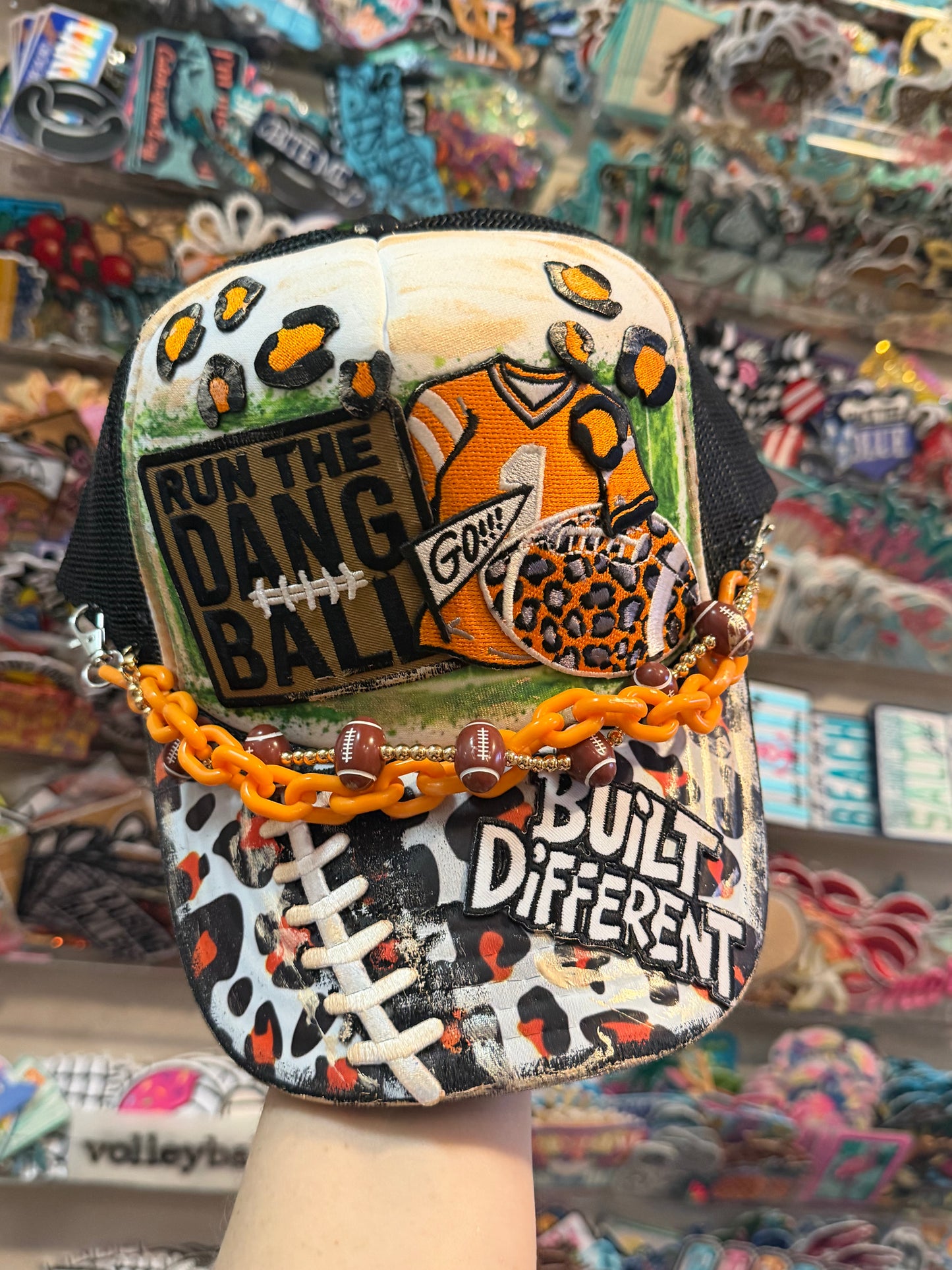 Blu Coconut black white and orange football trucker hat.