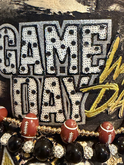 Black and gold leopard game day trucker hat